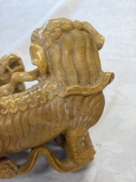 A fine Chinese soapstone group of Buddhist lions on wooden stand, 19th C.
