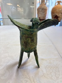 A Chinese archaic bronze wine vessel with Taotie design, Jue 爵, late Shang