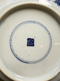 Eleven Chinese blue and white gadrooned 'Flowers and Peacocks' plates, Kangxi