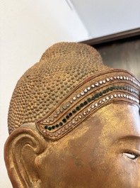 A very large Burmese mica-inlaid gilt-lacquered wooden Mandaly Buddha, 20th C.