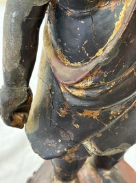 A rare Chinese gilt-lacquered bronze Buddha standing on a lotus throne, Ming