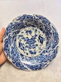 Eleven Chinese blue and white gadrooned 'Flowers and Peacocks' plates, Kangxi