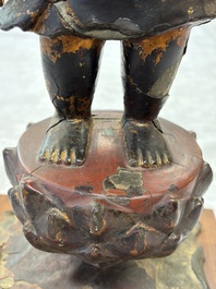 A rare Chinese gilt-lacquered bronze Buddha standing on a lotus throne, Ming