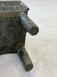 An inscribed Chinese archaic bronze food vessel with Taotie design, Ding 鼎, Western Zhou