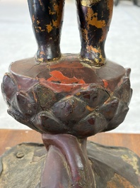 A rare Chinese gilt-lacquered bronze Buddha standing on a lotus throne, Ming