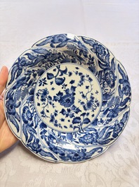 Eleven Chinese blue and white gadrooned 'Flowers and Peacocks' plates, Kangxi