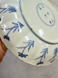 A Chinese blue and white 'Elegant Lady with Two Boys' plate with a 'Lotus Scroll' border, Kangxi