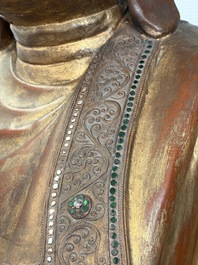 A very large Burmese mica-inlaid gilt-lacquered wooden Mandaly Buddha, 20th C.