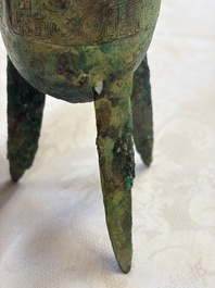 A Chinese archaic bronze wine vessel with Taotie design, Jue 爵, late Shang