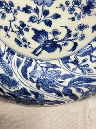 Eleven Chinese blue and white gadrooned 'Flowers and Peacocks' plates, Kangxi