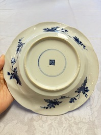 Eleven Chinese blue and white gadrooned 'Flowers and Peacocks' plates, Kangxi
