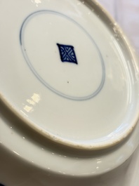 Eleven Chinese blue and white gadrooned 'Flowers and Peacocks' plates, Kangxi