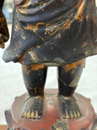 A rare Chinese gilt-lacquered bronze Buddha standing on a lotus throne, Ming