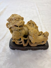 A fine Chinese soapstone group of Buddhist lions on wooden stand, 19th C.