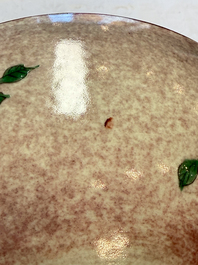 An unusual Chinese famille verte copper-red-ground shallow bowl with floral design, 19th C.