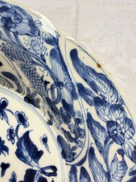 Eleven Chinese blue and white gadrooned 'Flowers and Peacocks' plates, Kangxi