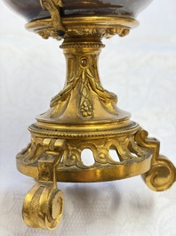 A pair of gilt-bronze-mounted Chinese famille rose capucine-ground vases and a covered bowl, Qianlong
