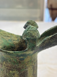 A Chinese archaic bronze wine vessel with Taotie design, Jue 爵, late Shang