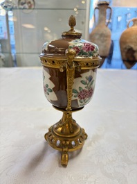 A pair of gilt-bronze-mounted Chinese famille rose capucine-ground vases and a covered bowl, Qianlong