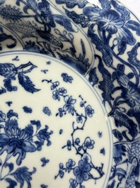 Eleven Chinese blue and white gadrooned 'Flowers and Peacocks' plates, Kangxi