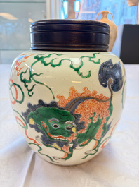 A fine Chinese famille verte 'Buddhist Lions' jar and a reticulated wooden cover, 19th C.