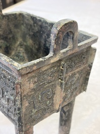 An inscribed Chinese archaic bronze food vessel with Taotie design, Ding 鼎, Western Zhou