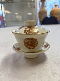 A fine Chinese iron-red gilt-decorated covered teabowl with a stand, Guangxu mark and of the period