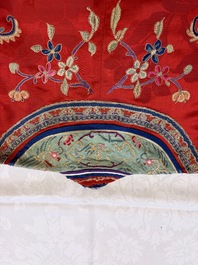 A Chinese embroidered silk red-ground women's robe, 19th C.