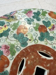 A Chinese famille rose garden seat with butterflies, flowers and fruiting branches, 19th C.