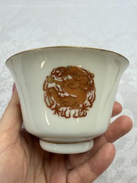 A fine Chinese iron-red gilt-decorated covered teabowl with a stand, Guangxu mark and of the period