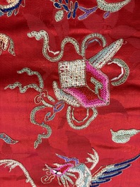 A Chinese embroidered silk red-ground women's robe, 19th C.