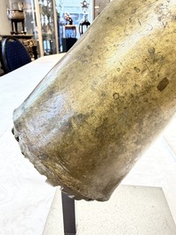 A rare and large Tibetan bronze forearm of a Buddhist figure with a chakra design, on a later metal stand, Qing