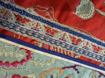 A Chinese embroidered silk red-ground women's robe, 19th C.