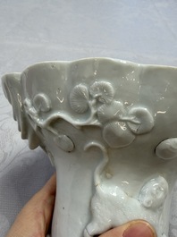 A very large Chinese Dehua blanc de Chine libation cup with a dragon, a qilin, a tiger and a crane, 18th C.