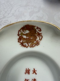 A fine Chinese iron-red gilt-decorated covered teabowl with a stand, Guangxu mark and of the period