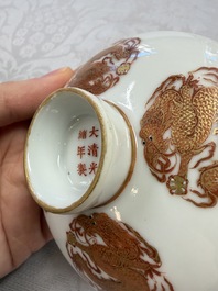 A fine Chinese iron-red gilt-decorated covered teabowl with a stand, Guangxu mark and of the period
