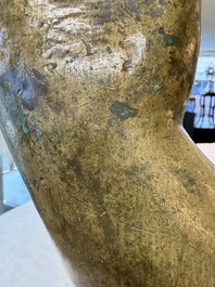 A rare and large Tibetan bronze forearm of a Buddhist figure with a chakra design, on a later metal stand, Qing