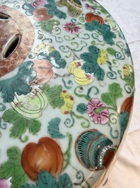 A Chinese famille rose garden seat with butterflies, flowers and fruiting branches, 19th C.