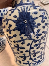 Two Chinese blue and white 'Lotus Scroll' vases and covers, Kangxi