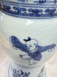 A pair of large Chinese blue and white 'Gu' vases with elegant ladies and playing boys, Kangxi