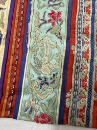 A Chinese embroidered silk red-ground women's robe, 19th C.