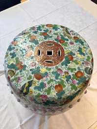 A Chinese famille rose garden seat with butterflies, flowers and fruiting branches, 19th C.