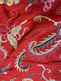 A Chinese embroidered silk red-ground women's robe, 19th C.