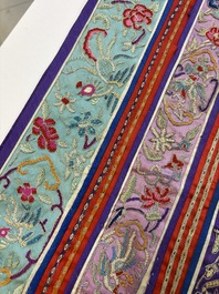 A Chinese embroidered silk red-ground women's robe, 19th C.