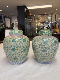 A rare pair of Chinese famille verte yellow-ground 'Flower Scroll' covered vases, Kangxi