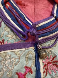 A Chinese embroidered silk red-ground women's robe, 19th C.