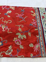 A Chinese embroidered silk red-ground women's robe, 19th C.