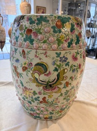A Chinese famille rose garden seat with butterflies, flowers and fruiting branches, 19th C.