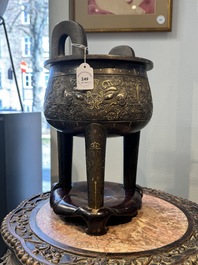 A rare Chinese gold- and silver-inlaid bronze 'Ding' censer with Taotie design on a hongmu stand, Shaosheng 紹聖 and Su Zhe 蘇轍 mark, Song or later