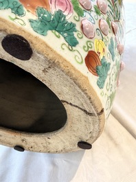 A Chinese famille rose garden seat with butterflies, flowers and fruiting branches, 19th C.